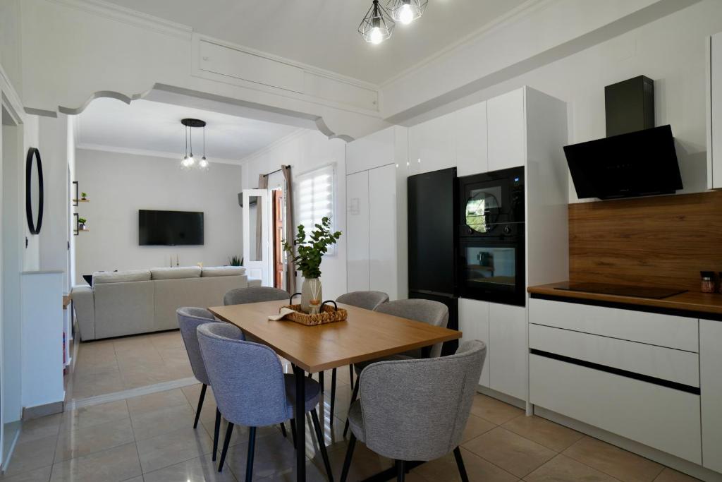 a kitchen and dining room with a table and chairs at BellaDiAnna Apartment in Symi