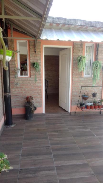 a porch of a house with a white door at Departamento Stella in Mina Clavero