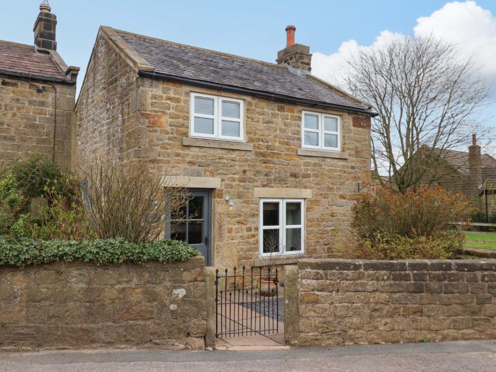 an old brick house with white windows at The Green in Ripon