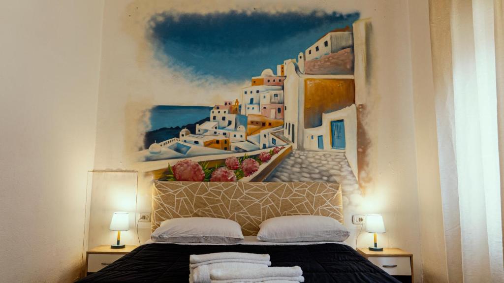a bedroom with a painting on the wall at Bed Rho Fiera - Milano Galeazzi in Rho