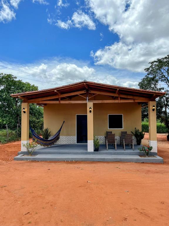 a house with a hammock in front of it at aconchego da serra in Coronel José Diaz