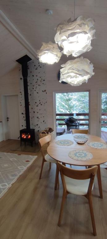 a living room with a table and a fireplace at Садиба Пташка in Krivopolʼye