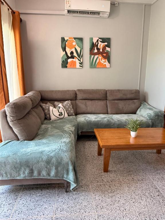 a living room with a couch and a table at T3 Duplex - Tsimkoura in Chirongui