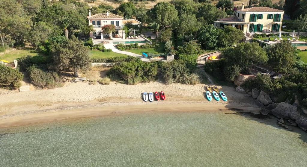 an aerial view of a beach with chairs on the sand at Aria & Iris in Kilada