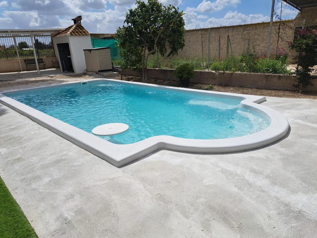 a swimming pool in the middle of a yard at La Casa de la Huerta de Redován in Redován