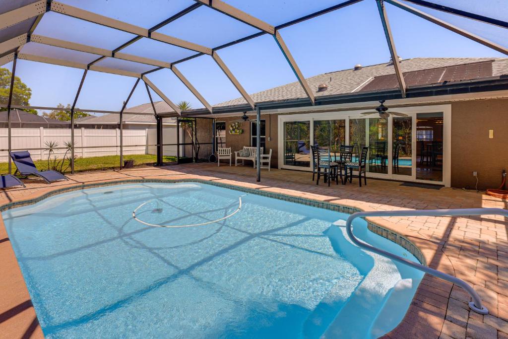 a swimming pool with a glass roof and a patio at Saltwater Pool! Sebring Oasis Near Lake Jackson in Sebring