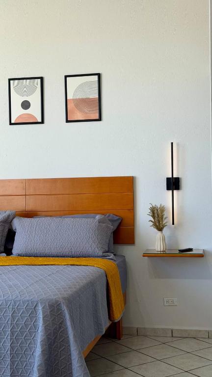 a bedroom with a bed with four pictures on the wall at Star Department We bill in La Paz