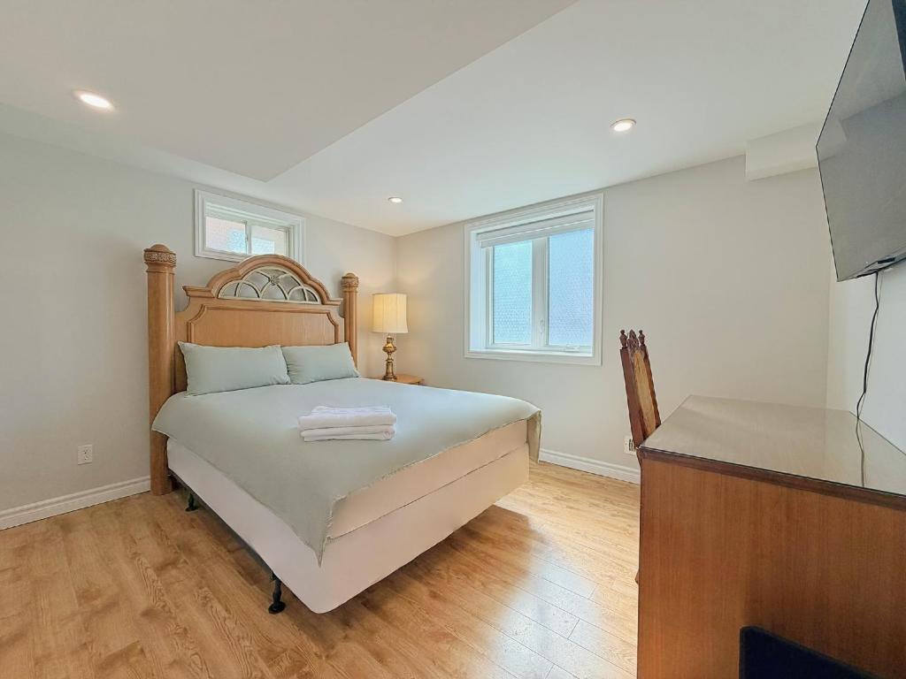 a bedroom with a bed with a dresser and a television at Cozy Rooms in Bright Walkout Suite - Newly Renovated in 2026 in Richmond Hill
