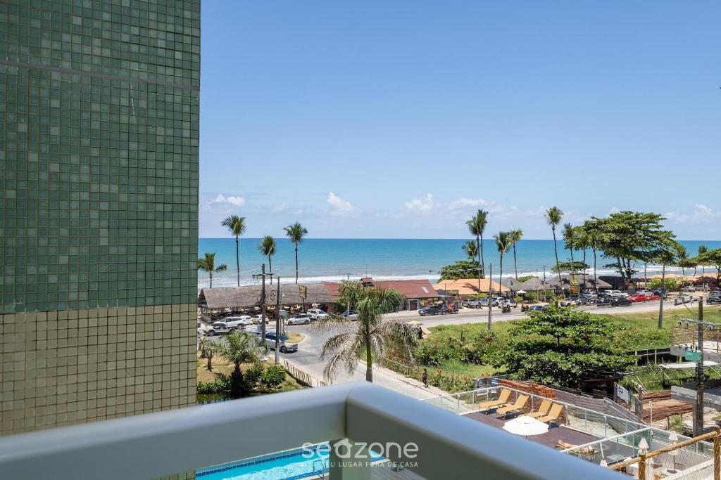 a view of the beach from the balcony of a resort at Condominium w/ pool and steps fr/ the beach - SRCs in Ilhéus