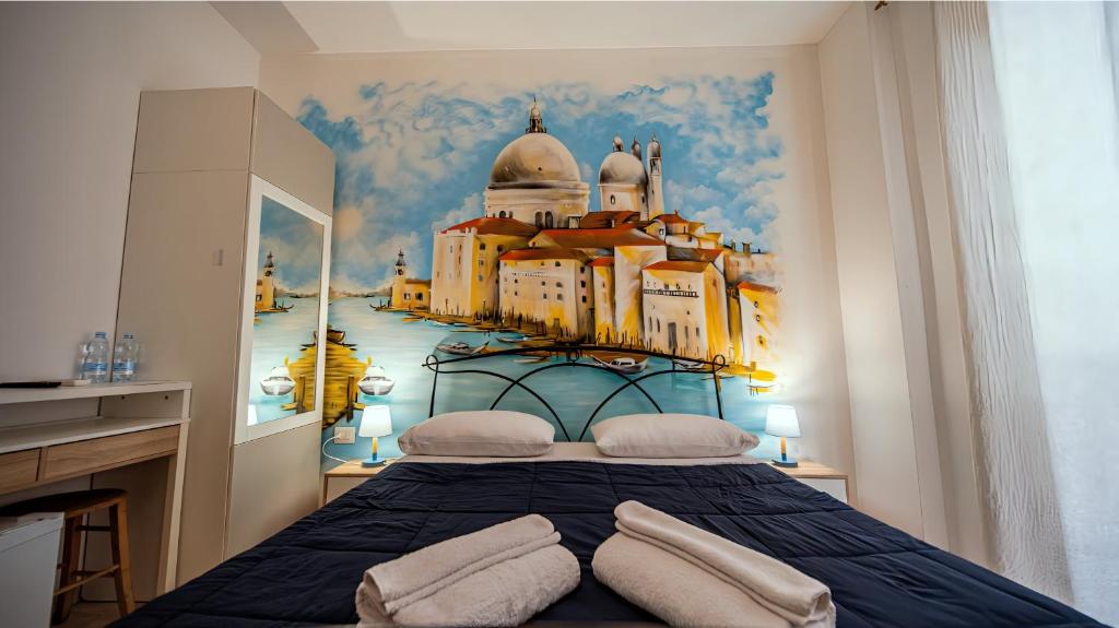 a bedroom with a bed with a painting of a city at Bed Rho Stazione - Fiera in Rho