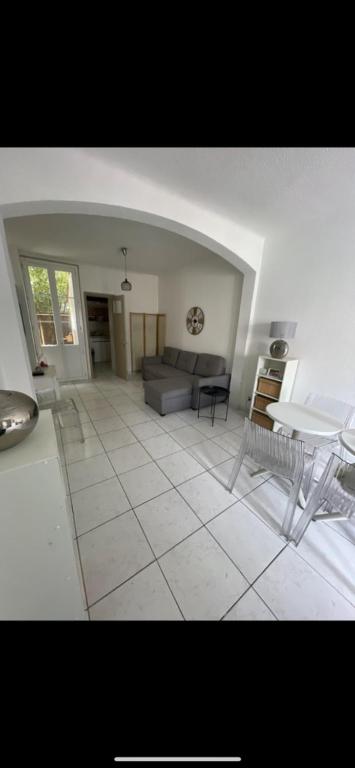a living room with a couch and a table at Nid douillet in Montpellier