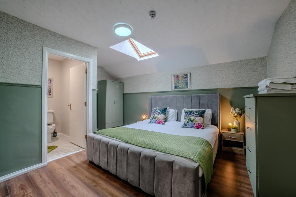 a bedroom with a large bed with green walls at Castle Inn in Newtownstewart