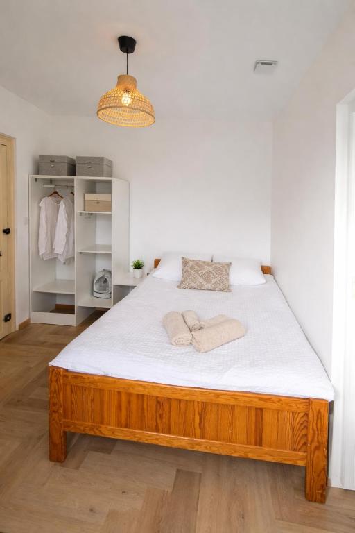 a bedroom with a large bed with white sheets at Studio moderne cosy Centre-ville in Auxerre