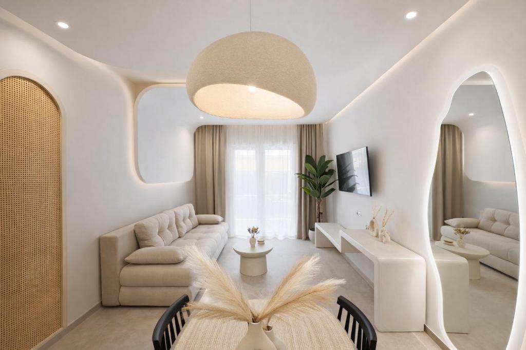 a living room with a couch and a table at NOÈA Luxury Suites in Kavála