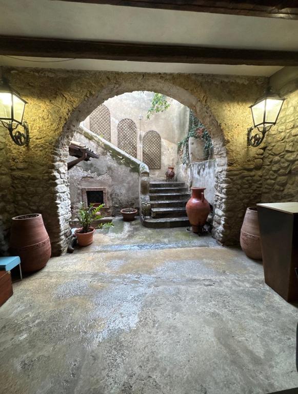 a stone hallway with an archway in a building at Palazzo Mascambruno in Cariati