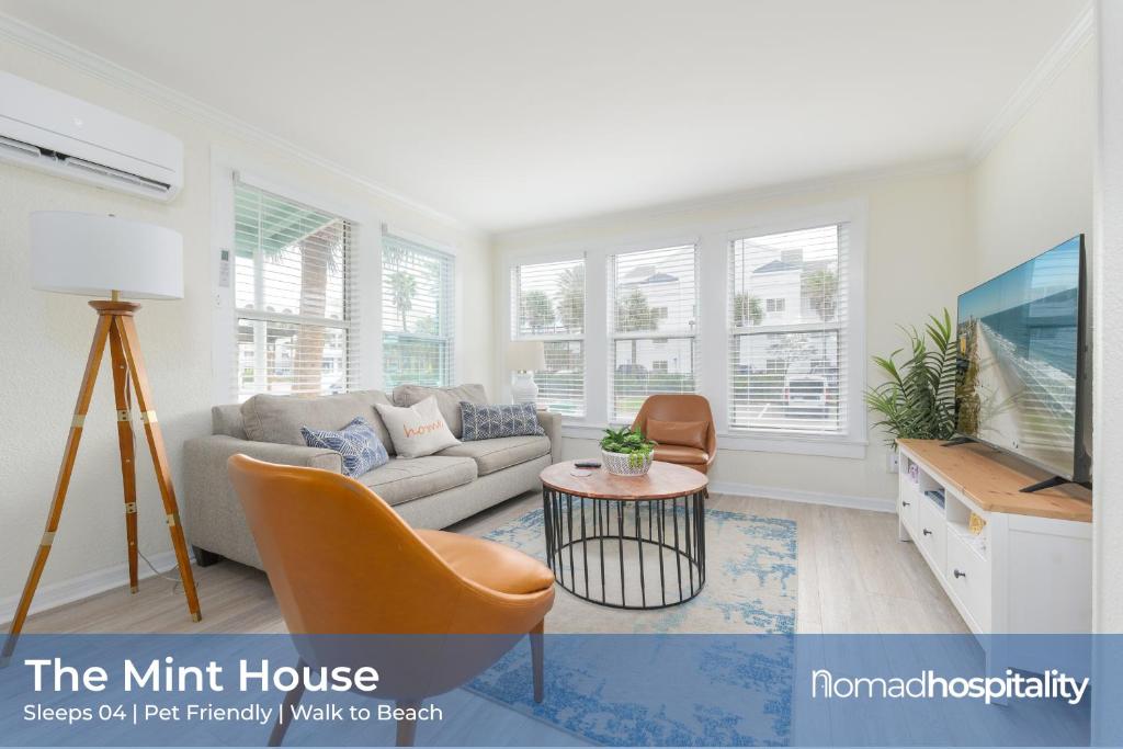a living room with a couch and a tv at Be A Nomad - 2BR Ground Floor Apartment Block to Jacksonville Beach in Jacksonville Beach