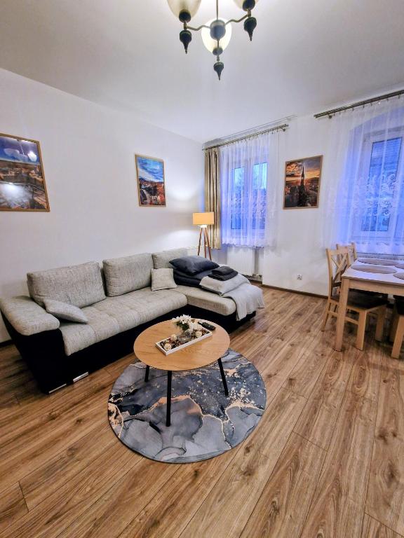 a living room with a couch and a table at Apartament Kris in Wałbrzych