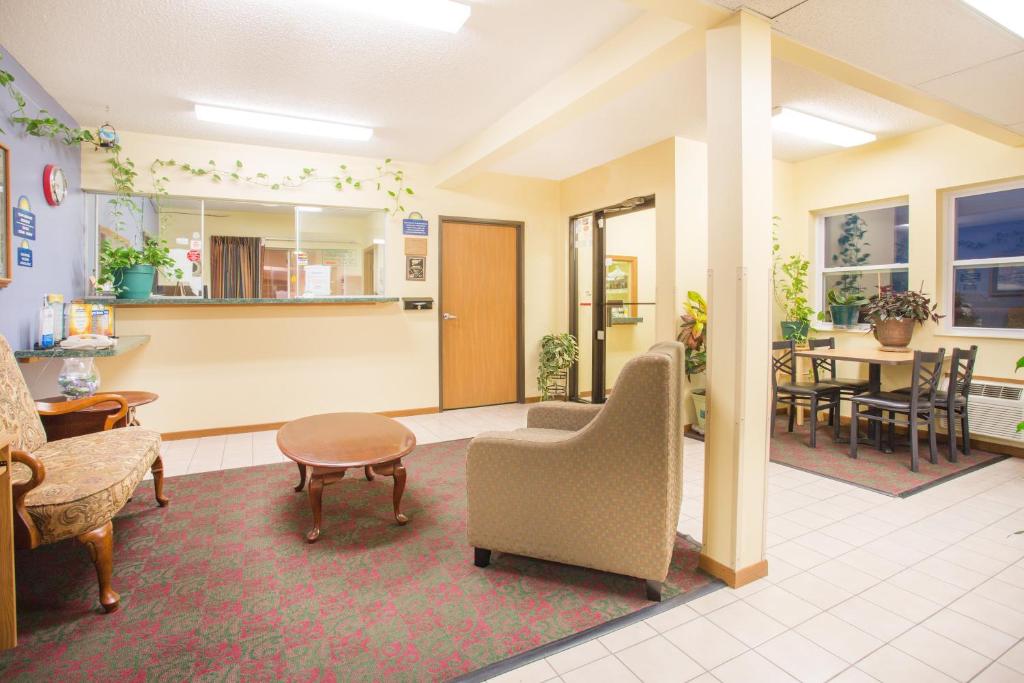 a waiting room with a chair and a table at Days Inn by Wyndham Lexington NE in Lexington