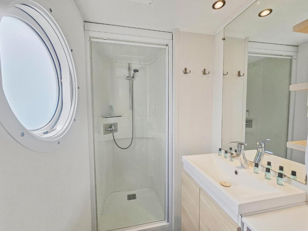 a bathroom with a shower and a sink at Mobilhome in Litteau
