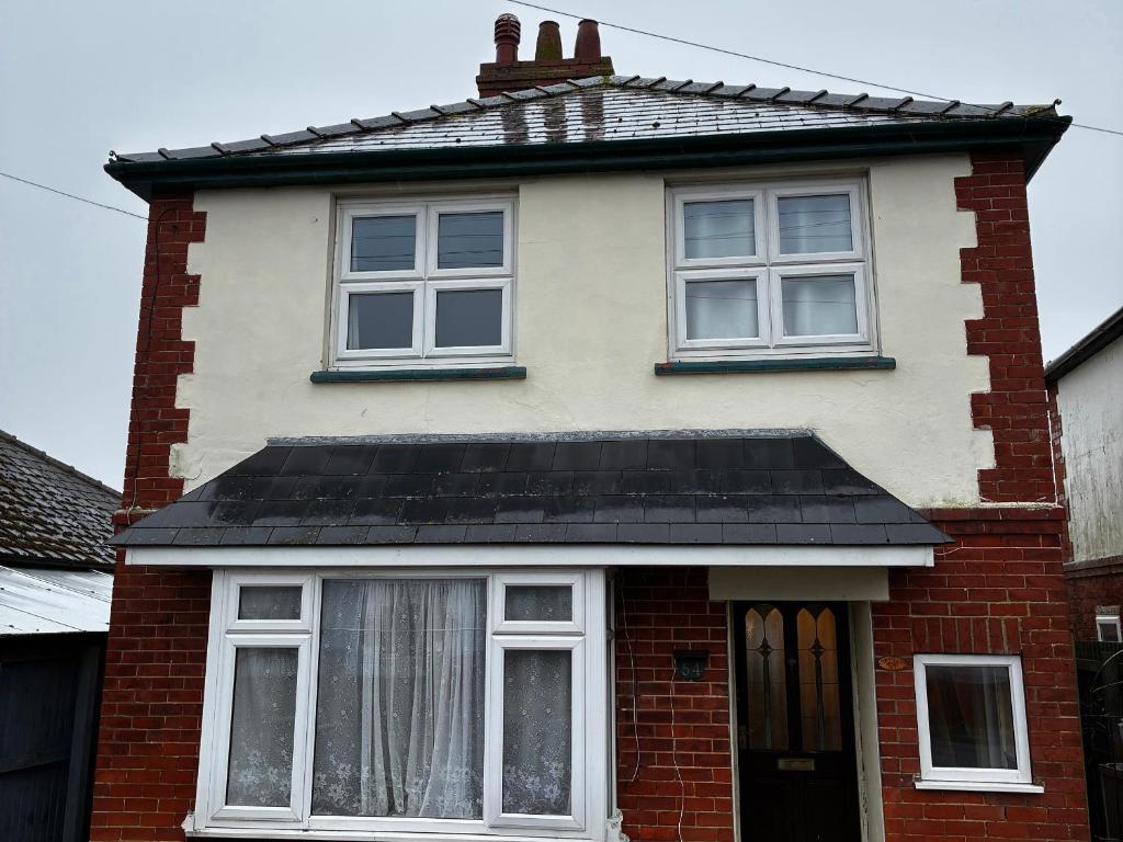 a red brick house with a black roof at 54 George Street in Mablethorpe