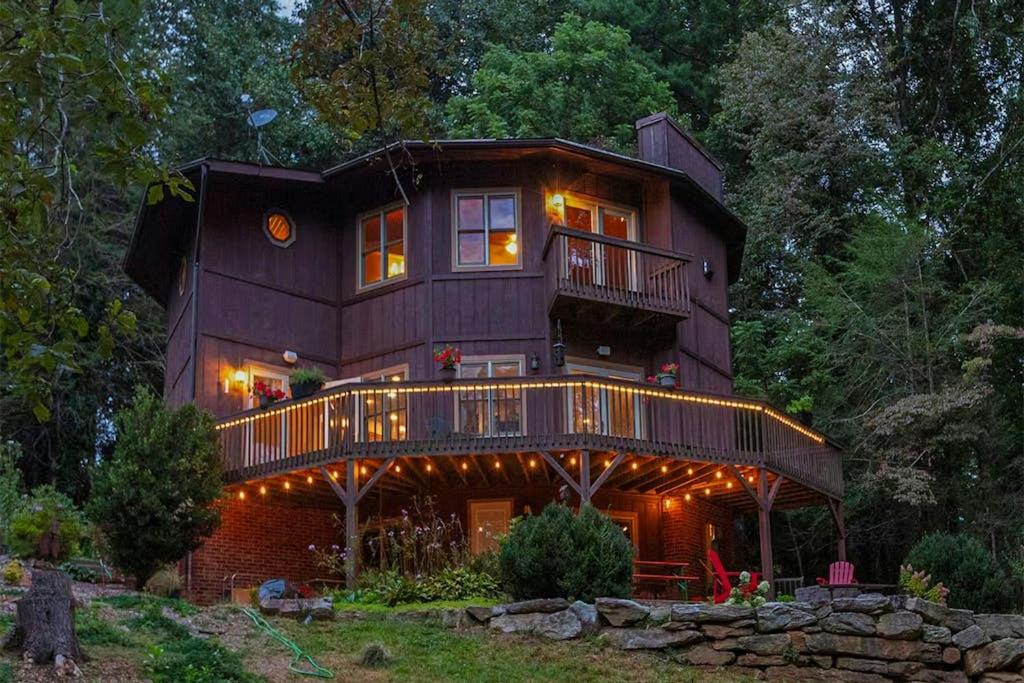 a large wooden house with a balcony on the side at Circular Mountain Retreat in Brevard