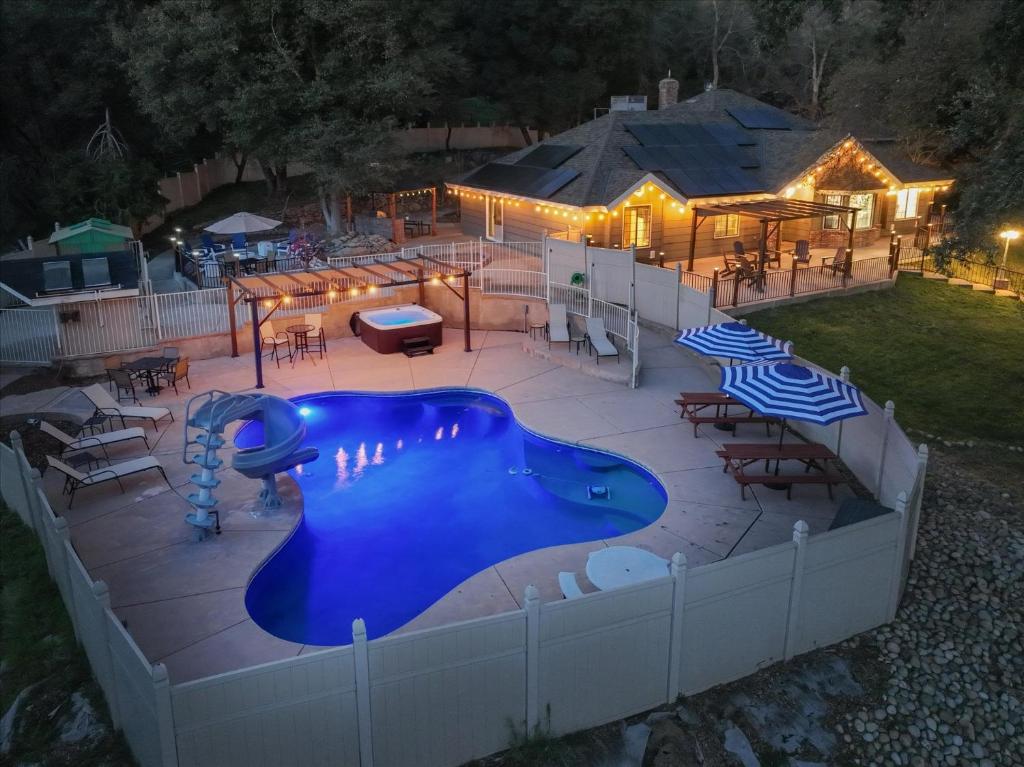 a swimming pool in a backyard at night at Splash Mountain in Oakhurst