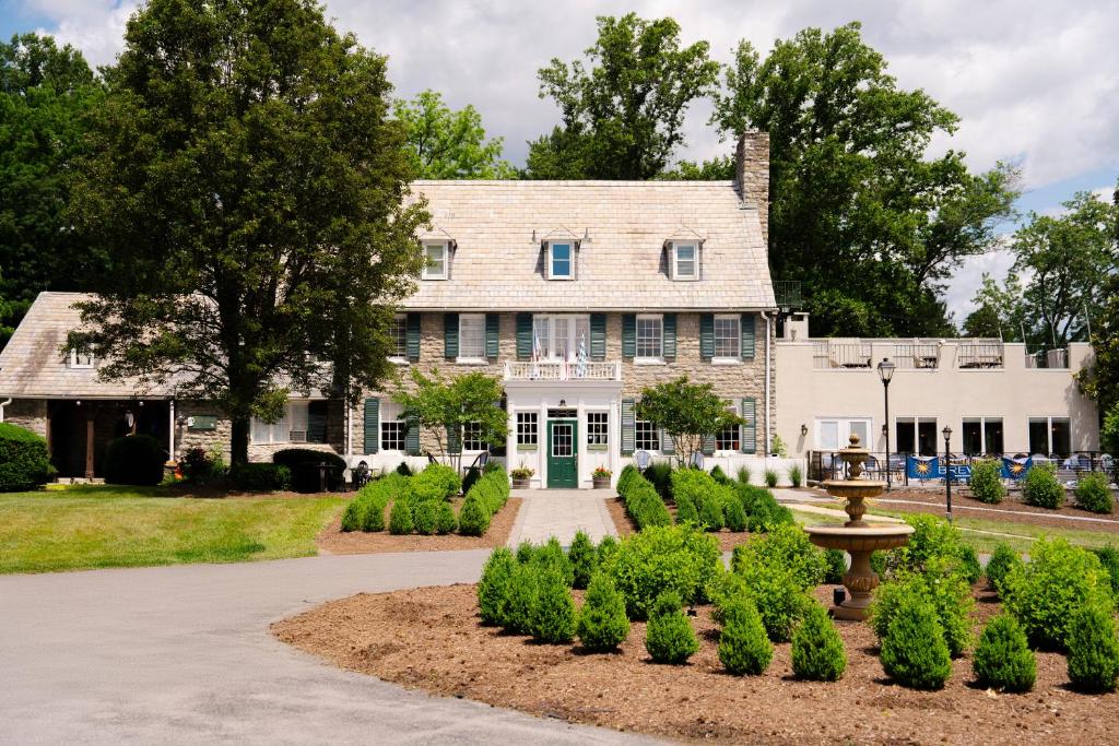 a large white house with a green door at Bavarian Inn in Shepherdstown