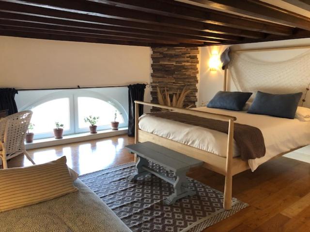 a bedroom with a large bed and a large window at Côté Baie avec parking-wifi- draps et serviettes in Hendaye