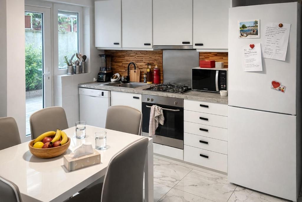 a kitchen with a table with a bowl of fruit on it at Always luxury for a luxurious life in Grimbergen