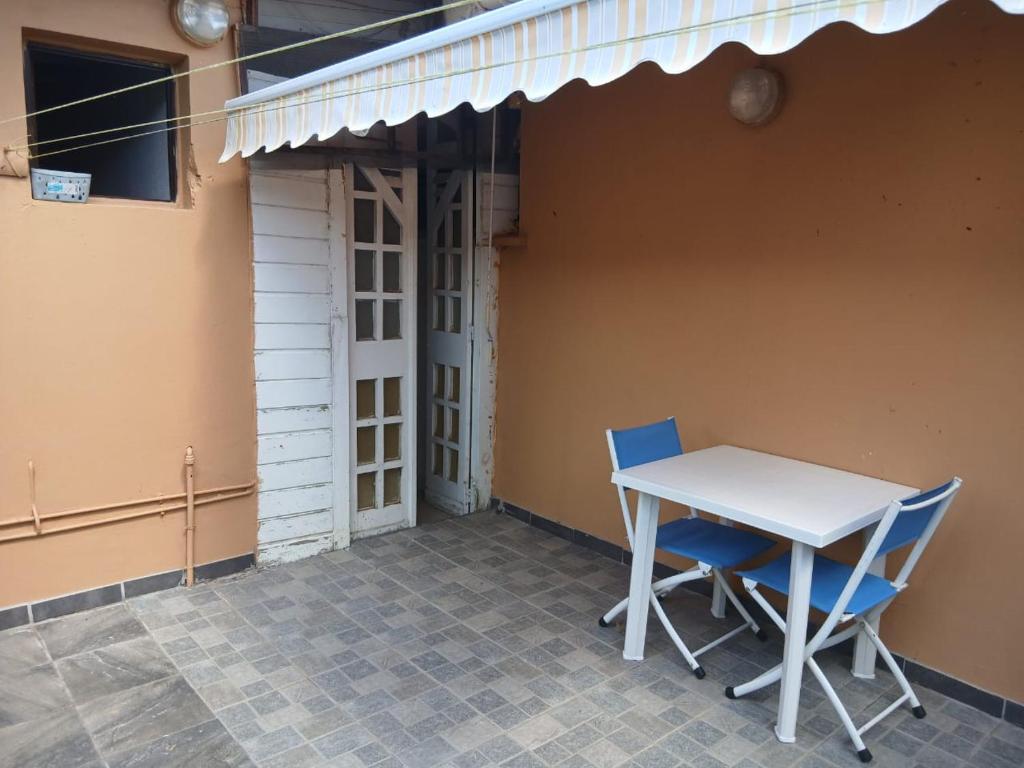 a table and chairs sitting on a patio at Chez Myky in Sainte-Marie