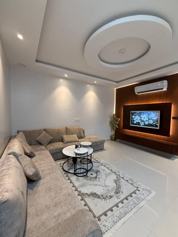 a living room with a couch and a tv at شـقـة بغـرفـتـيـن Two rooms in Al Kharj