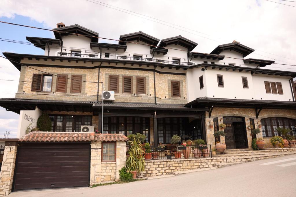 a large house with a garage in front of it at Hotel Panorama in Berat
