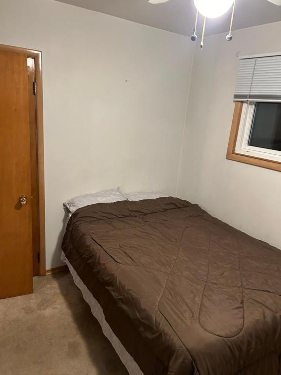 a bedroom with a bed in a room with a window at Home sweet home in Thunder Bay
