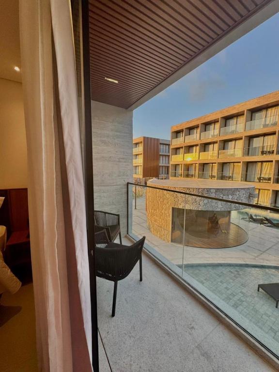a balcony with a view of a building at Flat em Porto life Resort in Porto De Galinhas