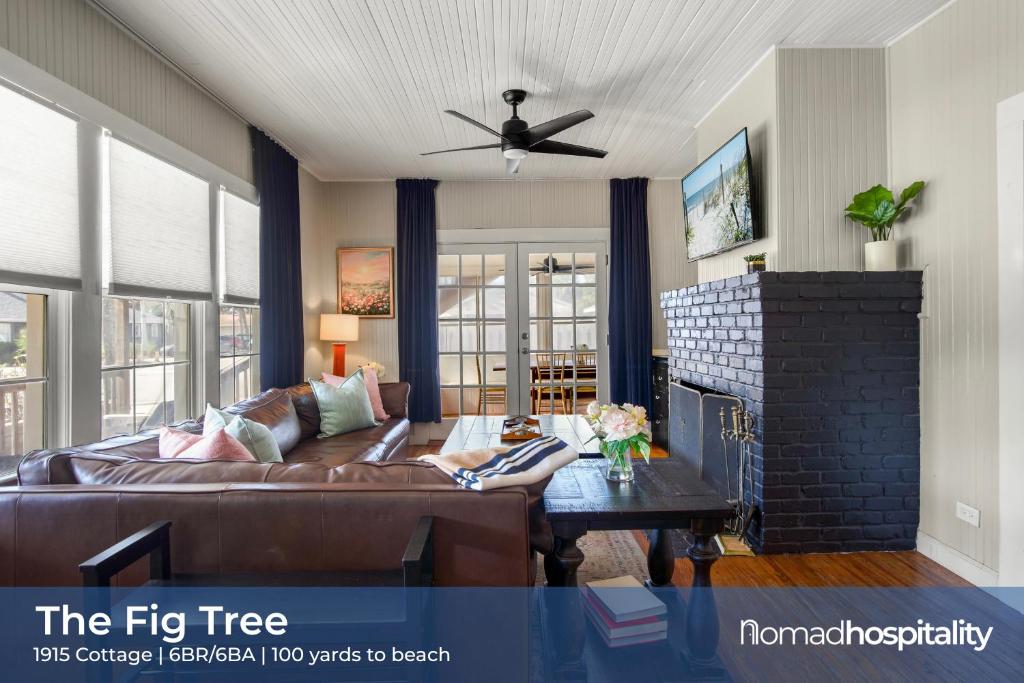 a woman laying on a couch in a living room at Be A Nomad - Historic 6BR Cottage Steps to Jacksonville Beach Sleeps 12 in Jacksonville Beach