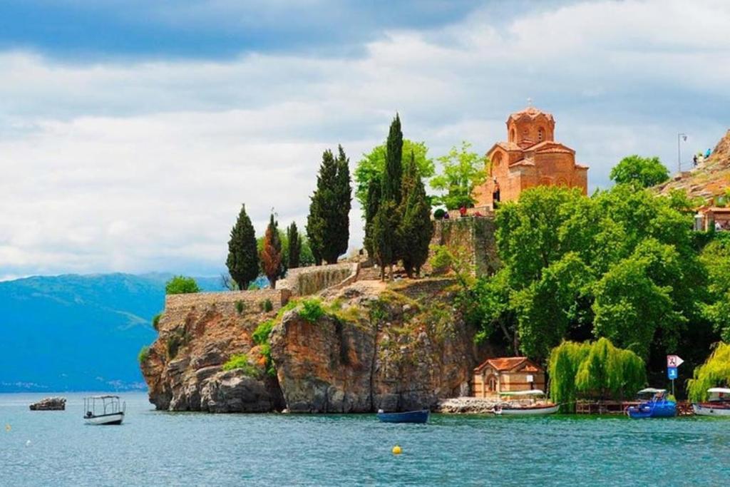 an island in the water with a church on it at Spacious Waterfront 3BR - 2Bath & 3 Panoramic Balconies - Pogradec, Lake Ohrid in Pogradec