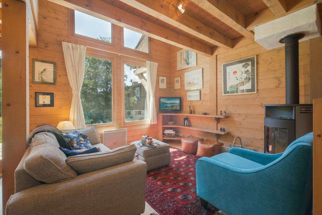 a living room with a couch and a fireplace at Chalets Zaria Garden Fireplace near Ski Lift - Happy Rentals in Argentiere