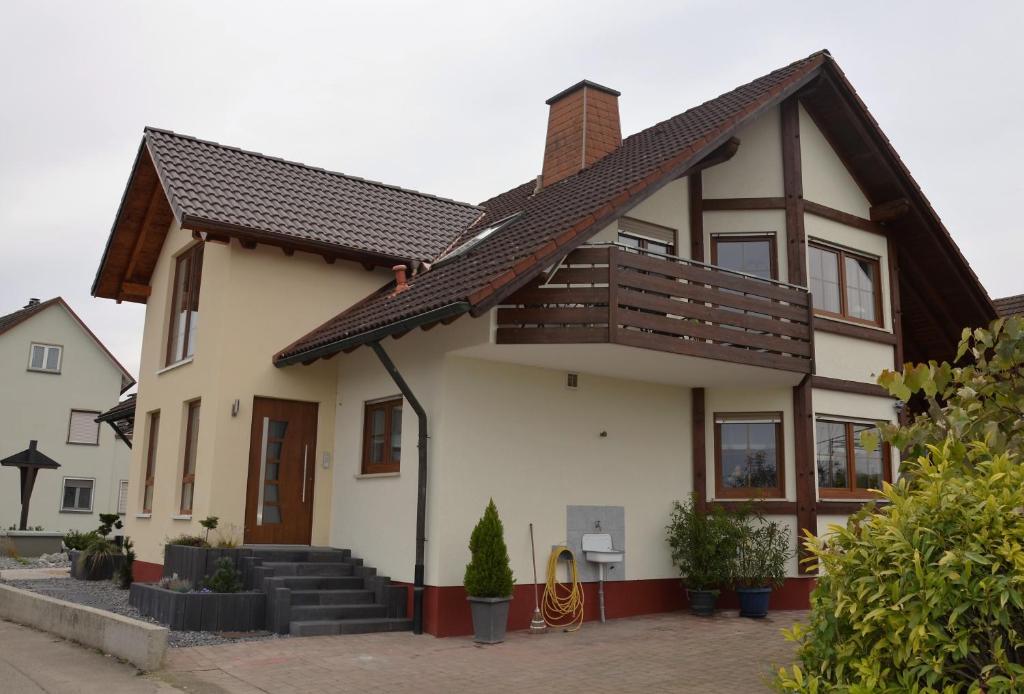 a white house with a brown roof at Ferienwohnung Sigrid in Forchheim