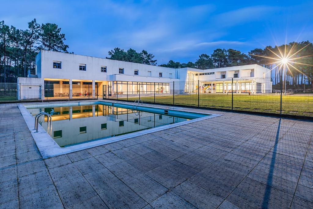 a swimming pool in front of a building at HI Ovar - Pousada de Juventude in Ovar