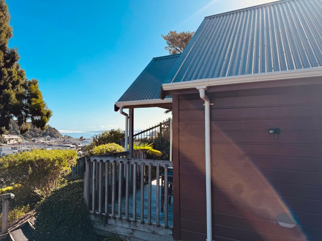 a brown house with a metal roof at Alba Pacis in Paihia