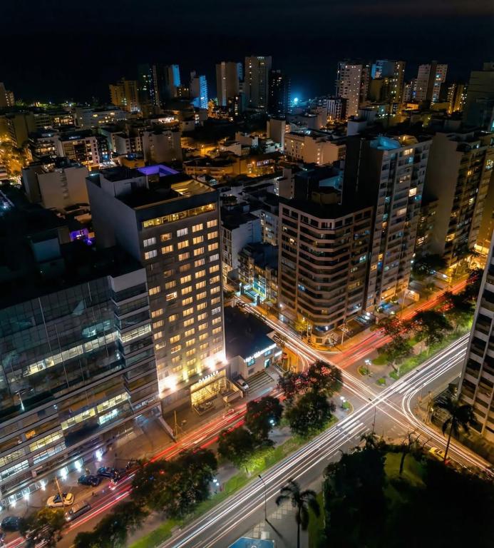 a city lit up at night with traffic at Dazzler by Wyndham Lima Miraflores in Lima