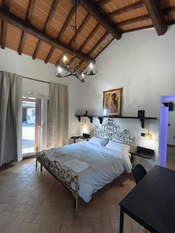 a bedroom with a large bed and a table at Il Quercetino di Momo in Ravenna