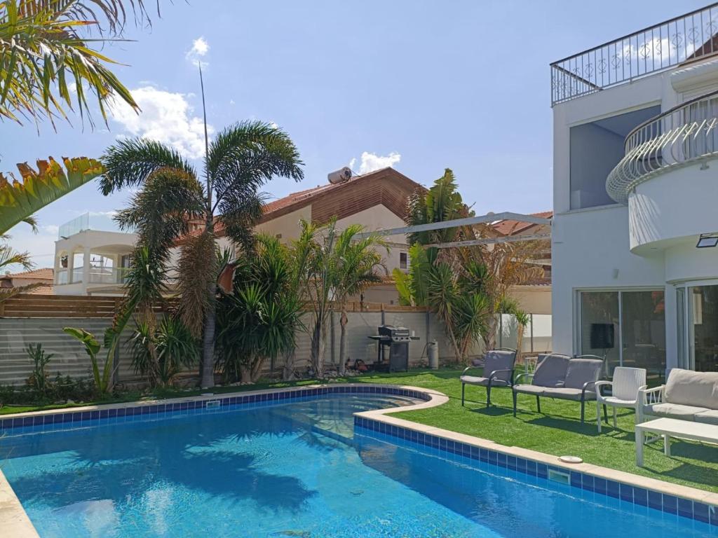 a swimming pool in the backyard of a house at Villa Dreamy Pool Garden in Eilat