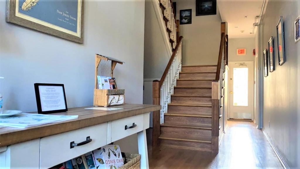 a hallway with a staircase with a wooden counter and a stair case at Somewhere In Time Unit 4 in Cape May Point