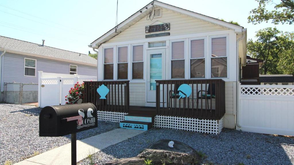 a small house with a gate and a fence at Shell Shack in Villas