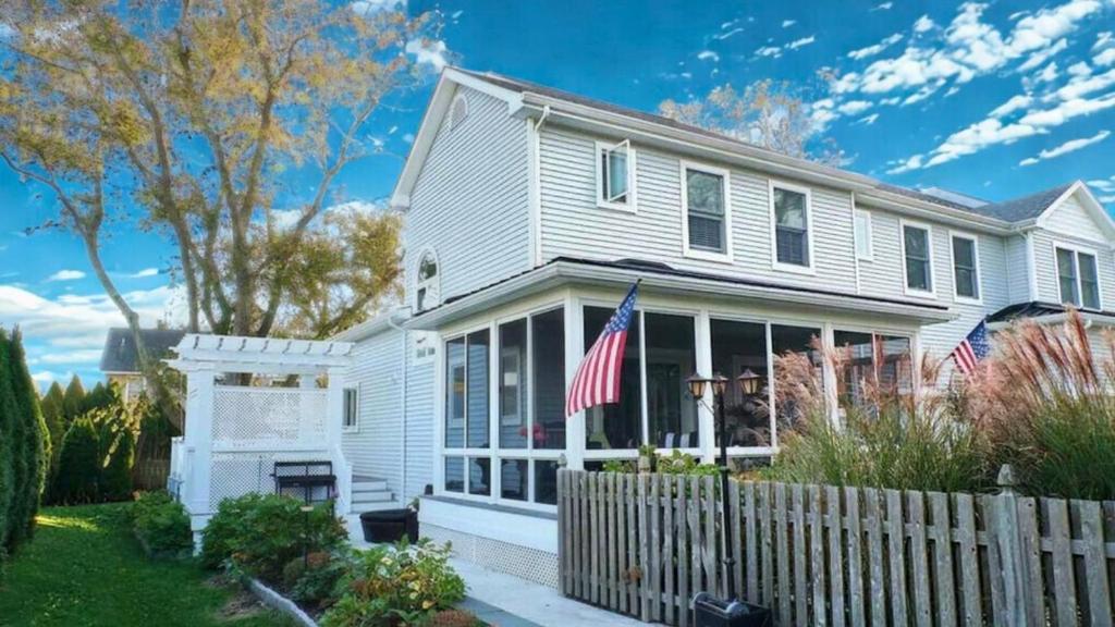 a white house with an american flag at 717 Broadway in West Cape May