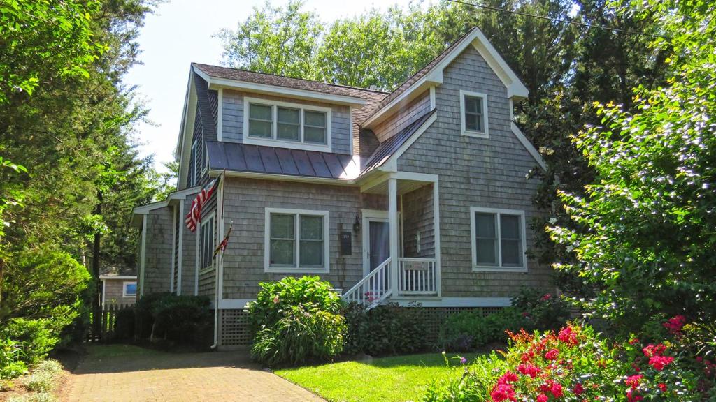 a house with a flag in front of it at Cedar Cottage in Cape May Point