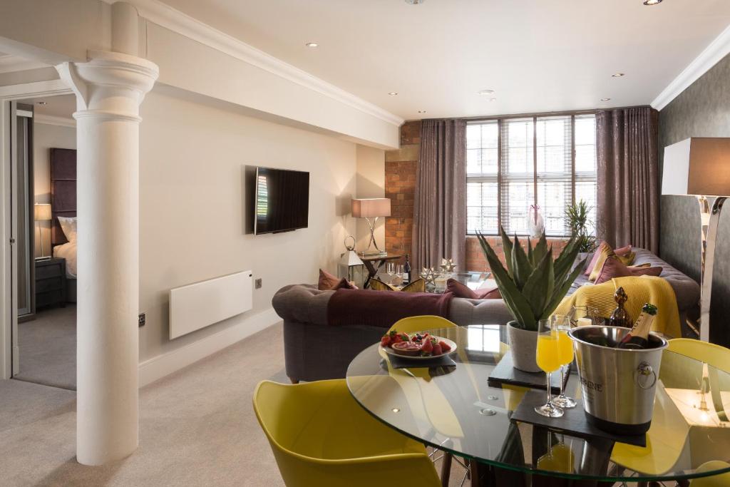 a living room with a table and yellow chairs at Serenity Inn the City in York
