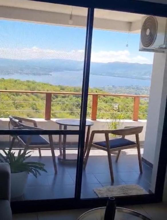 a view of a balcony with a table and chairs at Departamento Tierralta in Malagueño
