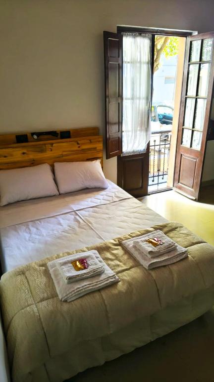 a bedroom with a bed with two towels on it at La Cruz Apart in Corrientes